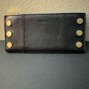 Wallet. Carefully used black with gold disc embellishments.